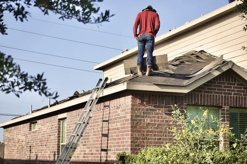 Professional roofer working on a residential roof in Runnymede